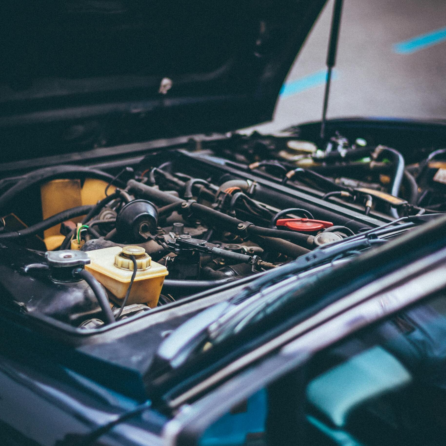 Detailed view of an exposed car engine under maintenance in Barcelona.